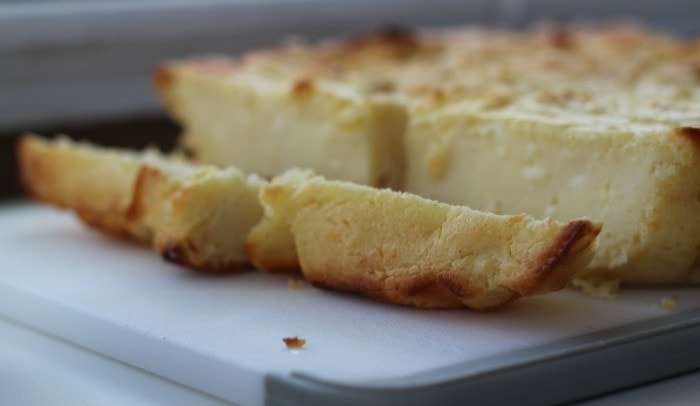 Costa Rican Tamal de Masa sliced on a cutting board.