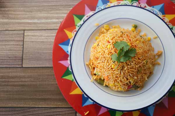 Costa Rican red plate with arroz con pollo and cilantro.