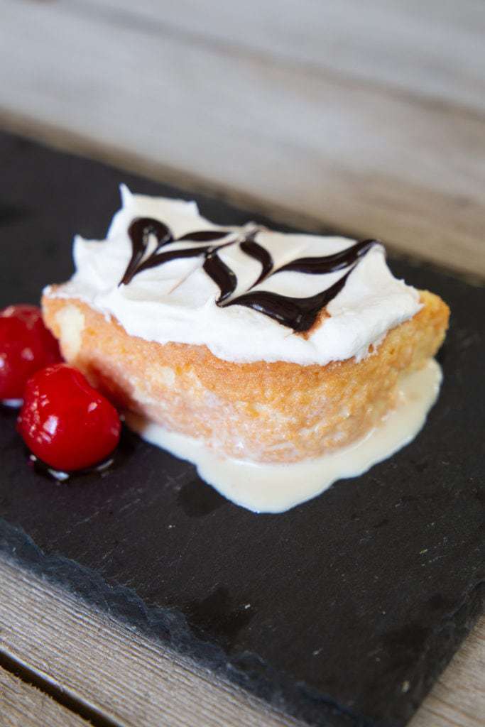 moist tres leches cake with cherries and chocolate