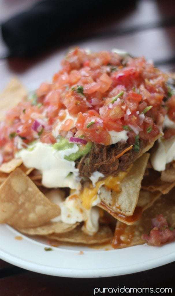 Nachos loaded with shredded beef, pico de gallo, sour cream, and guacamole.