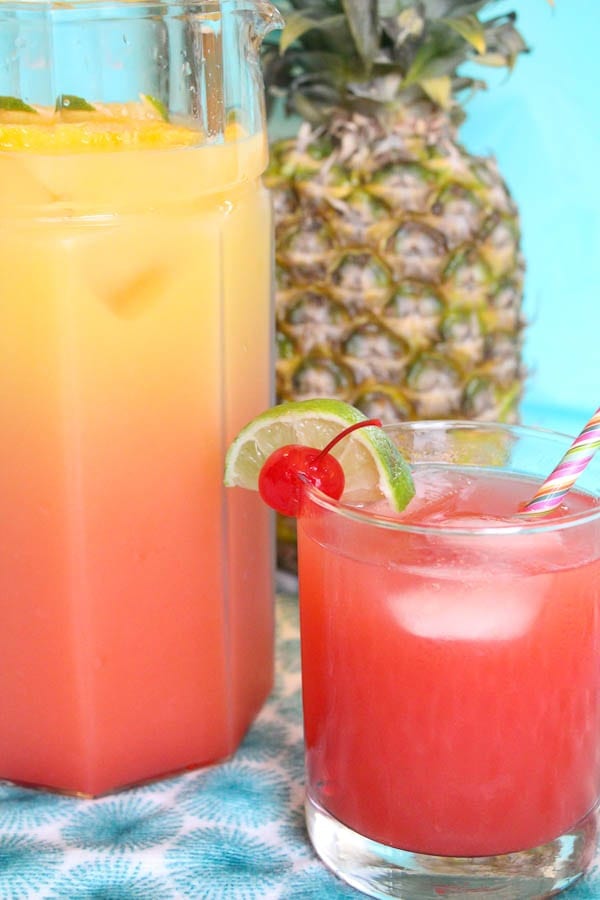 rum punch in glass and pitcher