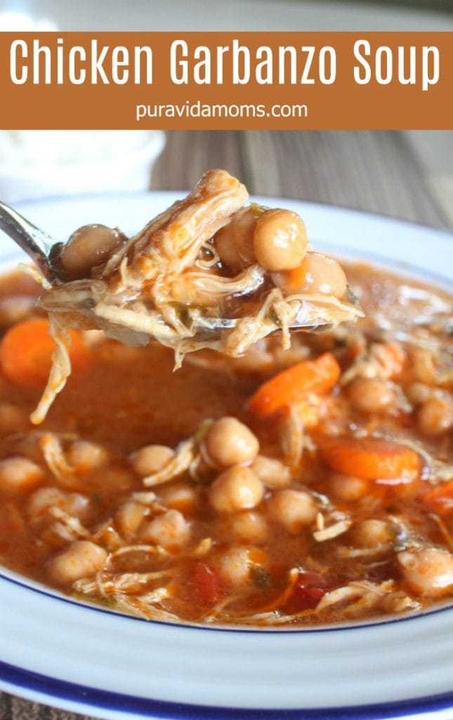 A spoon lifting up some of the chick pea soup.