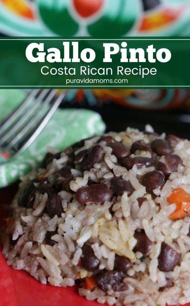 A red bowl of rice with a fork.