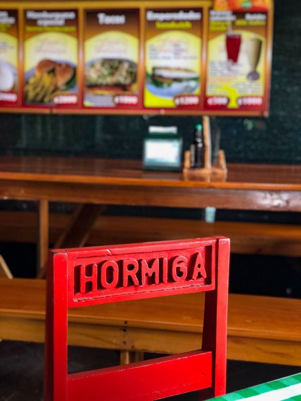 red chair and menu at soda la hormiga la fortuna