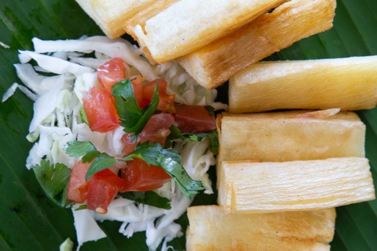Fried yucca served with cabbage salad and chimichurri sauce.