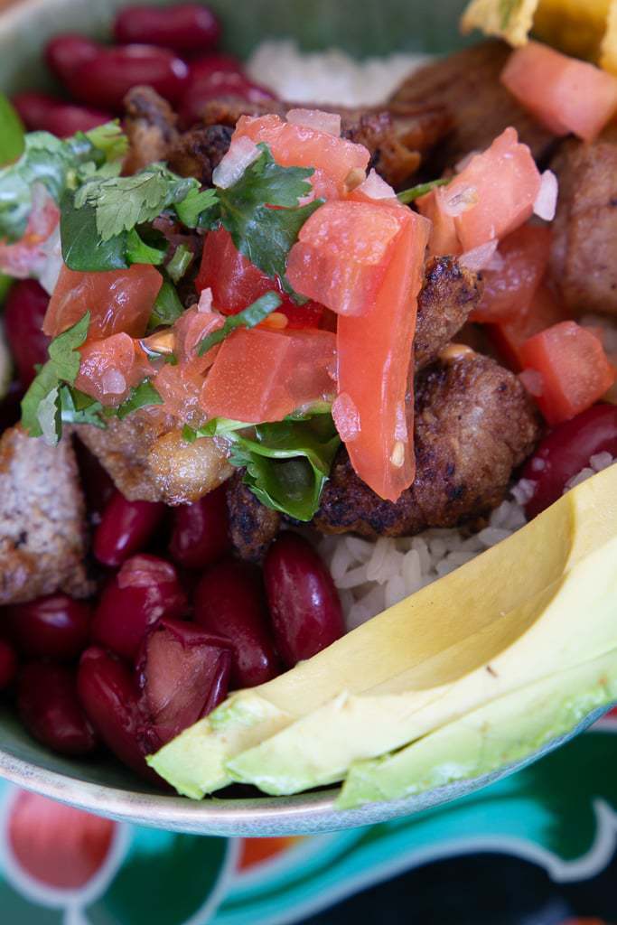white rice, kidney beans, fried pork, pico de gallo and avocado slices