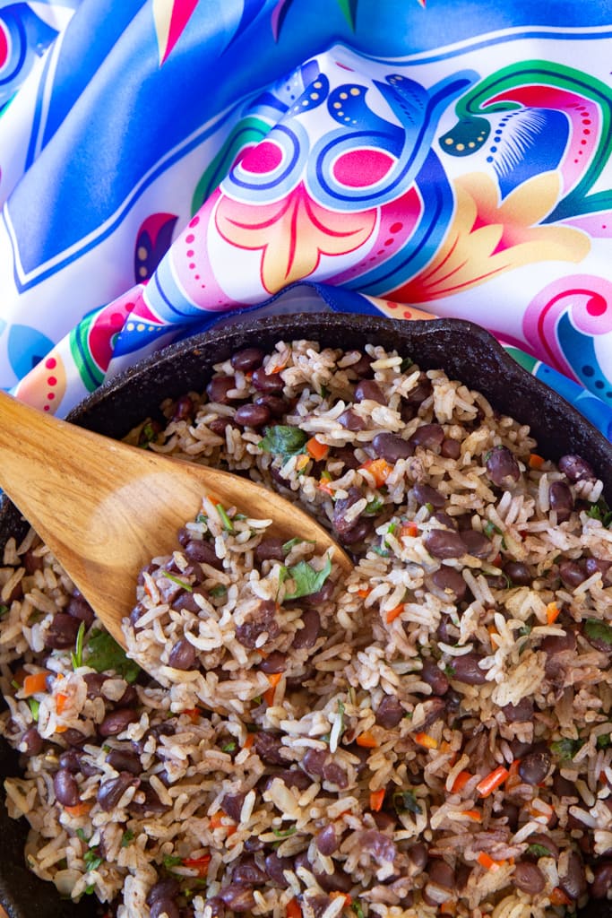 costa rican gallo pinto with wooden spoon and brightly colored scarf napkin