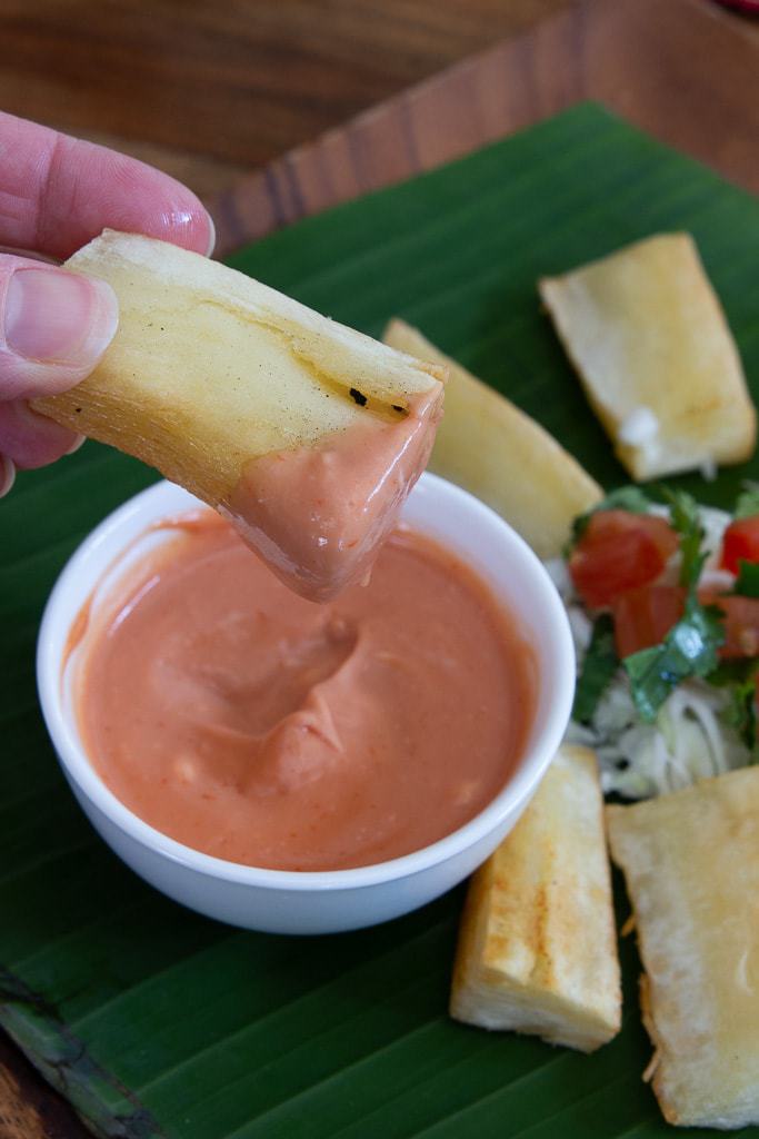 yuca fry dipped in pink sauce