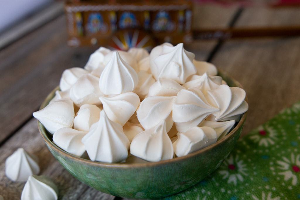 Suspiros costa rican cookies with traditional costa rican ox cart in the background