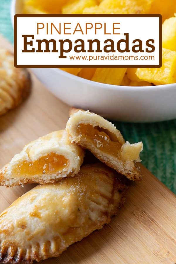 A pineapple empanada cut in half to reveal the inside.