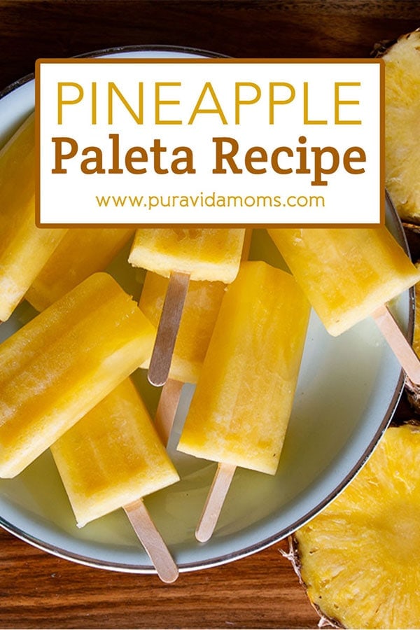 Multiple pineapple popsicles on a serving dish.