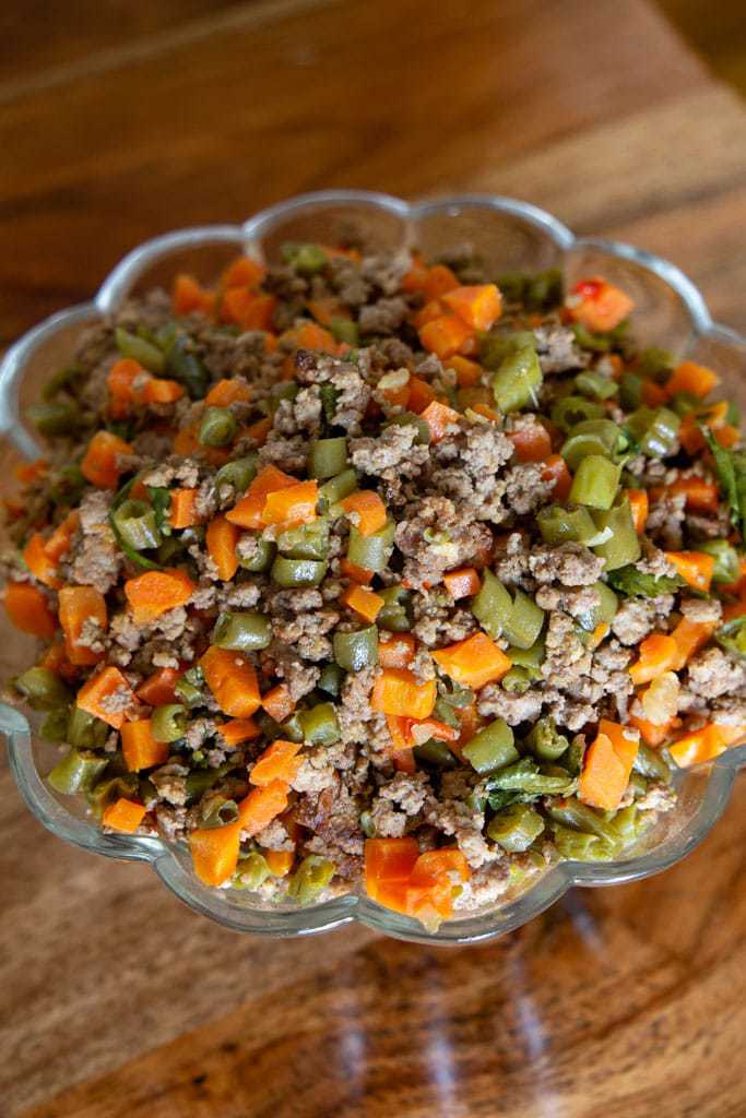 cropped image of costa rican picadillo in scalloped edged bowl.