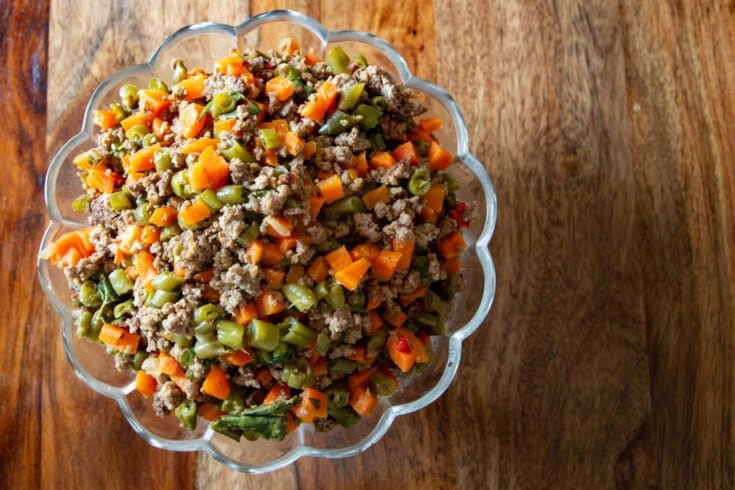 picadillo de vainica in scalloped edge glass bowl on table.