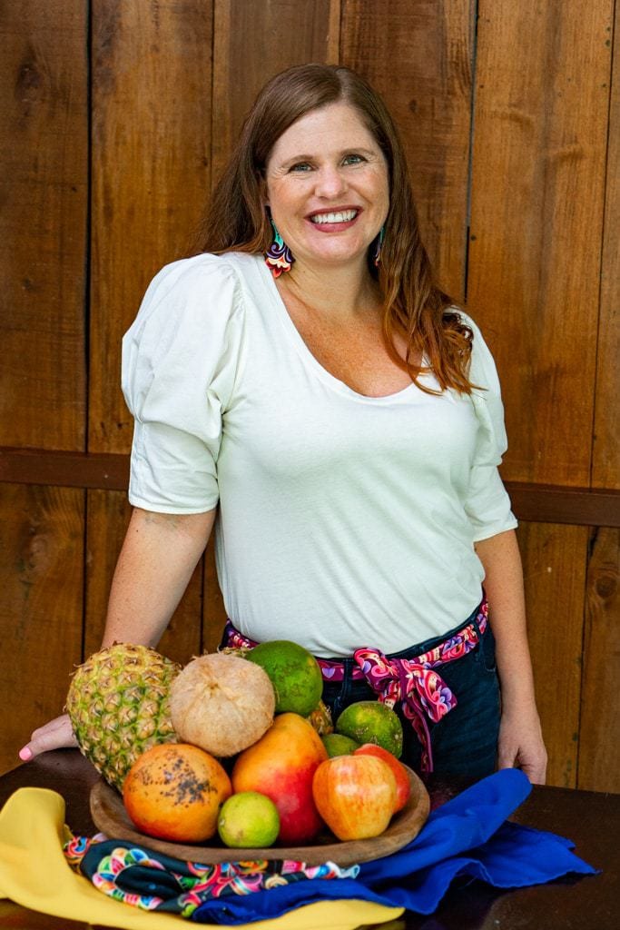 DSC07918 christa jimenez wearing costa rican jewelry and belt standing next to fruit bowl.