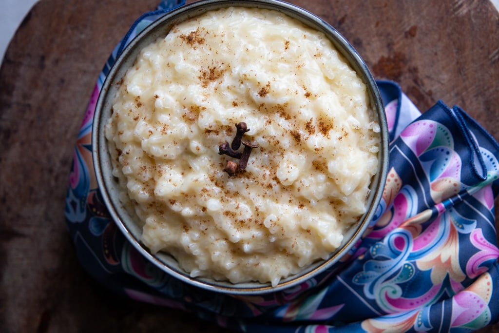 full bowl of homemade arroz con leche accented with lovely pastel scarf.