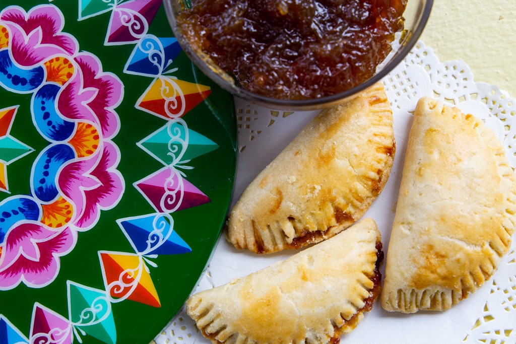 costa rican empanadas de chiverre on a doily with a pretty plate
