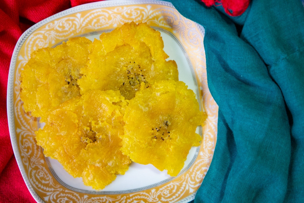 costa rican plantains- patacones on a plate with red and blue napkins