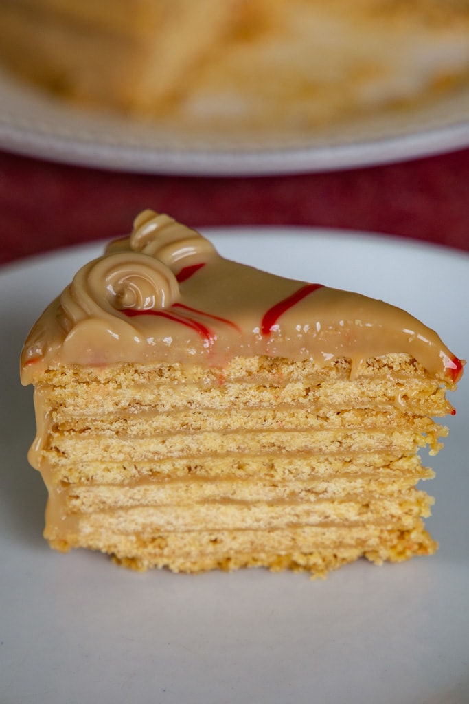 a slice of Torta Chilena Costa Rica on a white plate