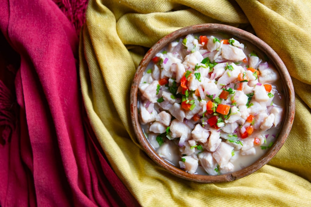 A bowl of the fish on a yellow cloth on top of a red cloth.