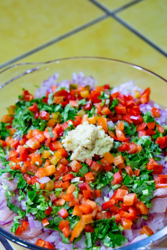 An array of ingredients and a serving bowl to make fish ceviche.